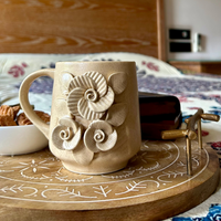 Handcrafted Beige Ceramic Mug with Embossed Floral Design