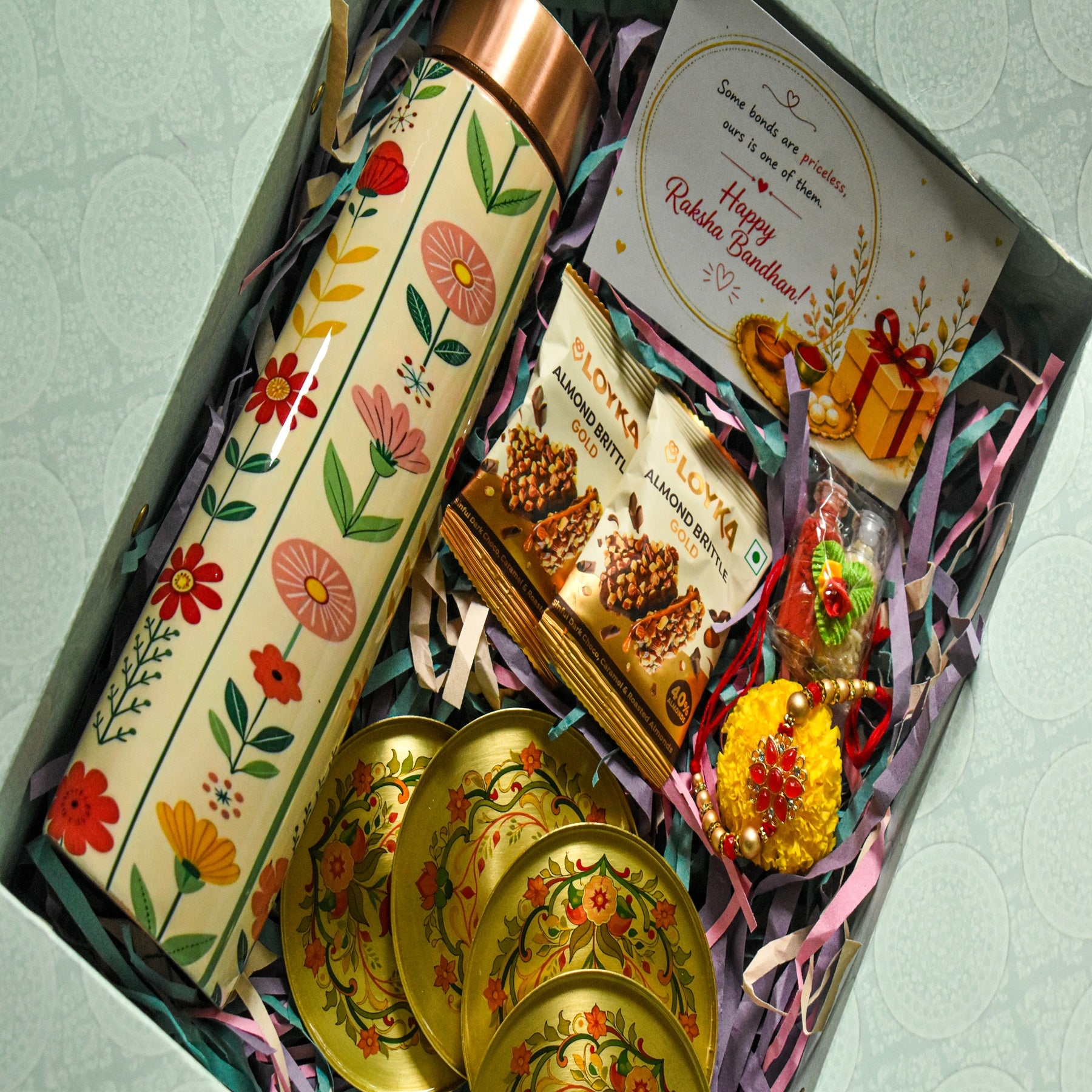 Premium Rakhi Gift Box- Phoolkari Copper Bottle +Brass Coaster Floral Set Of 4